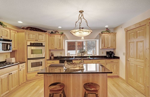 Eagle River House | Waterfront townhome with fireplace, private patio, & shared boat docks