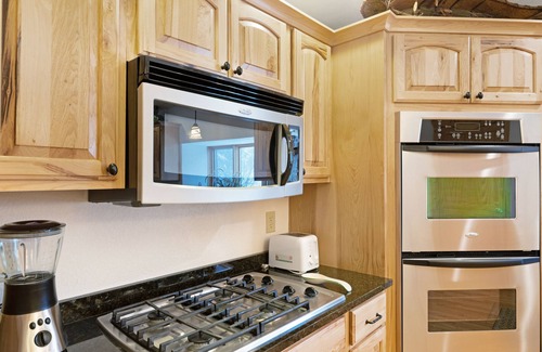 Eagle River House | Waterfront townhome with fireplace, private patio, & shared boat docks