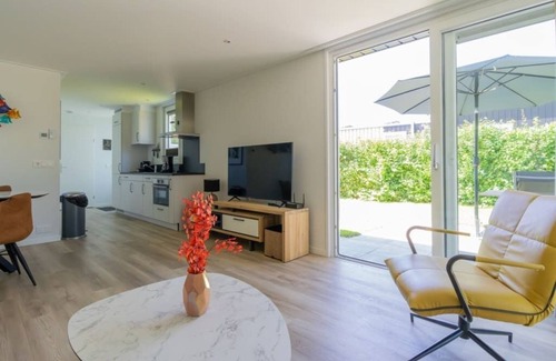 Burgh-Haamstede House | What immediately catches your eye upon entering is the garden-oriented living room with open kitchen