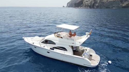 Santa Cruz de Tenerife Boat Rental | Yacht Experience Tenerife 24h plus Tour with private Skipper & private Hostess all inclusive with Cocktails, Sandwiches, free Minibar and free islandwide pick-up and return in a Tesla S Sportscar