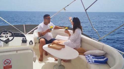 Santa Cruz de Tenerife Boat Rental | Yacht Experience Tenerife 24h plus Tour with private Skipper & private Hostess all inclusive with Cocktails, Sandwiches, free Minibar and free islandwide pick-up and return in a Tesla S Sportscar