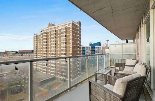 5 min walk to Stampede | 2BR | AC | UG Parking