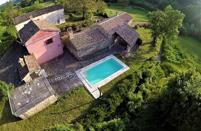 An ancient stone house surrounded by nature.