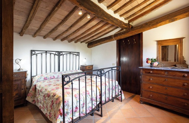 Attic room with exposed beams, rustic Tuscan style