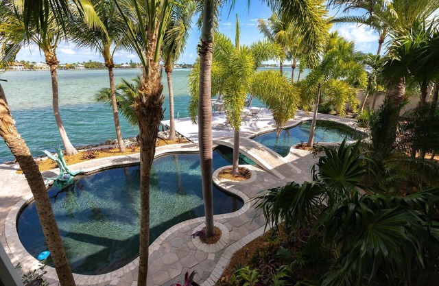 Bayside Beauty: Tropical Paradise 3BR Home, Panoramic Open Water Views, Grotto Pool, Dog-Friendly