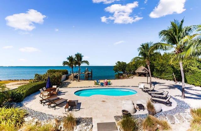 Beachfront charmer with dock, furnished balcony, firepit, & W/D - dog-friendly