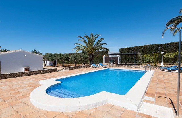 Beautiful complex of three houses with garden and community pool.