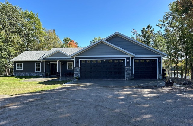 BEAUTIFUL lake front home with a private beach, dock and large yard
