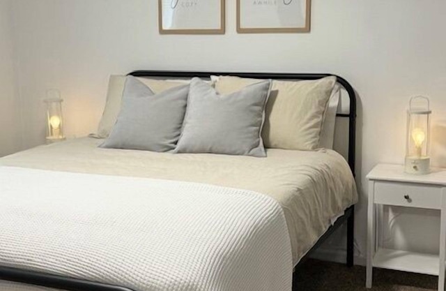 Completely Renovated home comfortably accommodates your stay with a queen bed in the primary bedroom, a twin bed with a pull-out trundle in the second bedroom, and a sleeper sofa in the living room for additional guests.