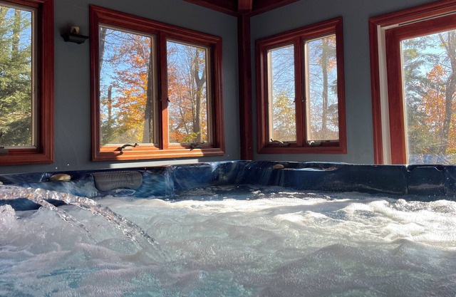 Cozy home featuring a large deck w/enclosed hot tub, game room and seasonal pool