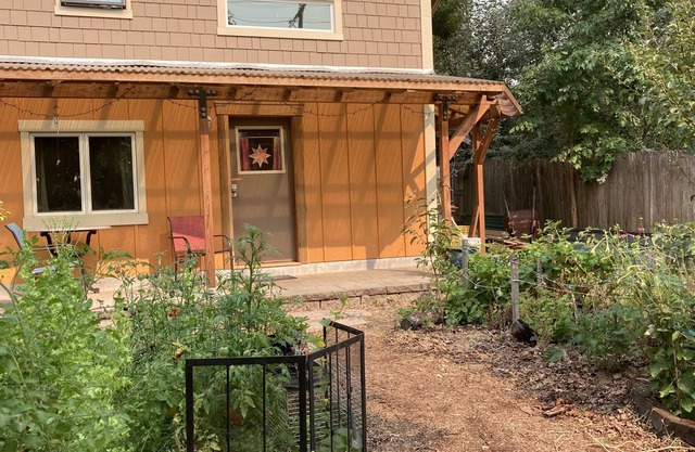 Custom Built Tiny House in an organic backyard garden