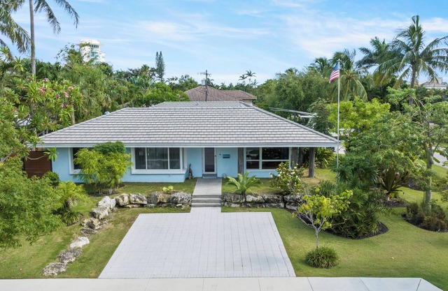 Custom remodeled home with tropical setting in exclusive Harbor Inlet community