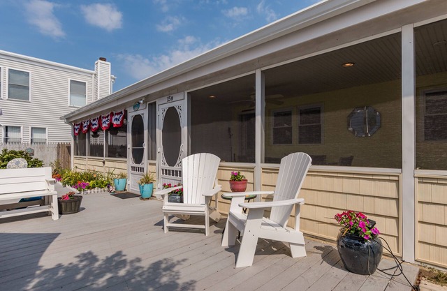 Enjoy the screened in porch just steps from the beach.