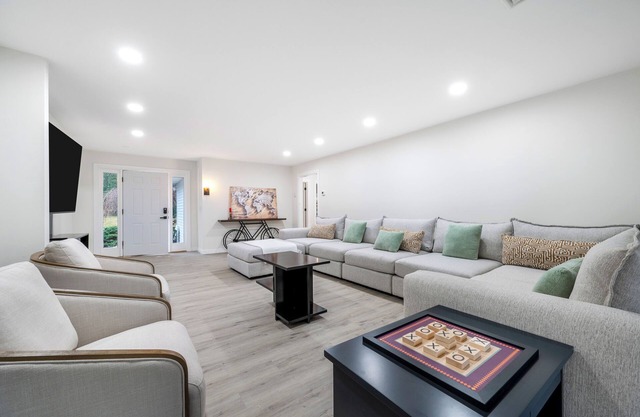 Features two living rooms, sauna, hot tub, and fire pit -over 4 acres of land.