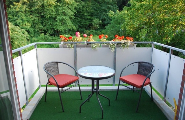 grand 2-room apartment (70m²) with balcony, central but located in green landsca