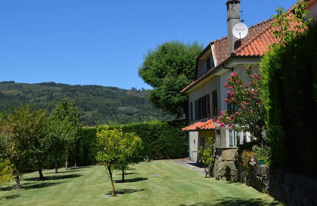 Large stone house in a wooded property with swimming pool