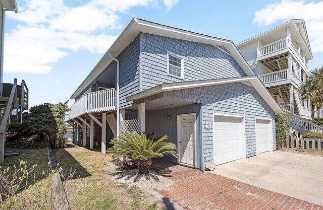Located directly on canal w/beautiful water front views — one block from beach