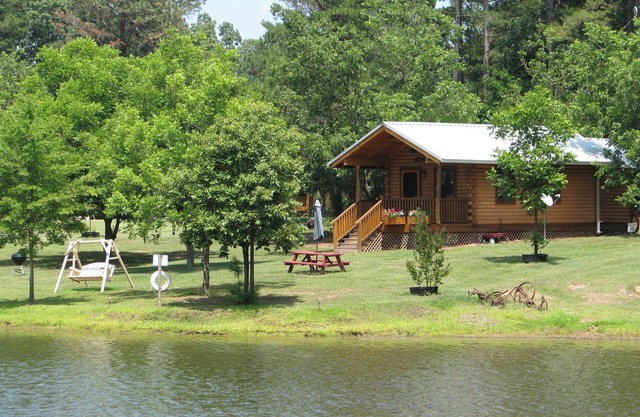 Log cabin overlooking a private lake on a working farm