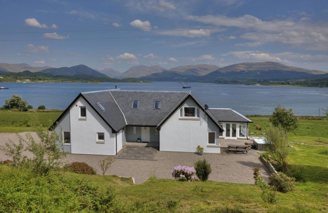 Luxury,large waterfront property with outdoor hot tub on shore of Scottish Loch.