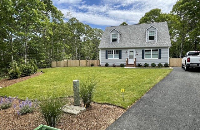 New construction cape house close to shops and 3 miles from the beach .