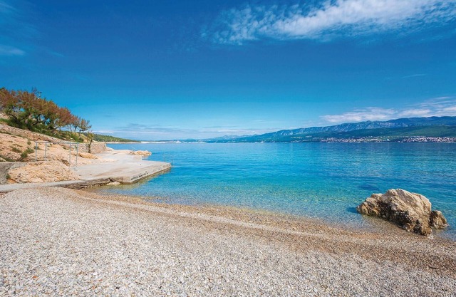 On the island of Krk welcomes you this beautiful apartment with shared pool.