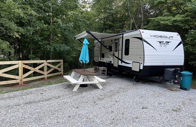 Quaint camper in a private area with full hook ups!