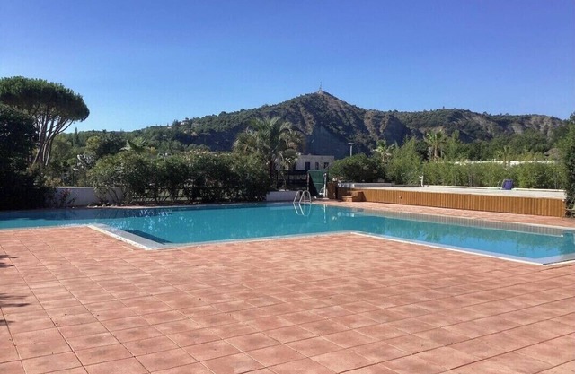 Quiet, bright apartment with private garden and shared pool.