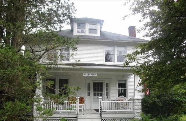 Relax on the covered front porch at "Allegheny" in Eagles Mere