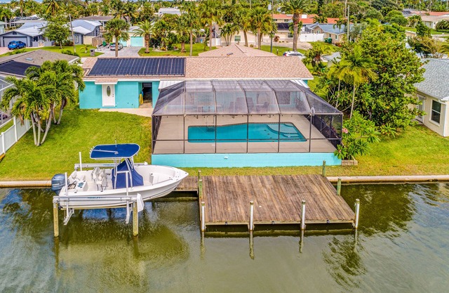 Riverfront home with private heated pool, dock, AC & W/D - dog-friendly