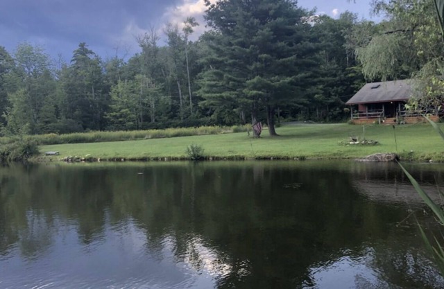Rustic escape on a pond with 7 acres in Colebrook, CT!