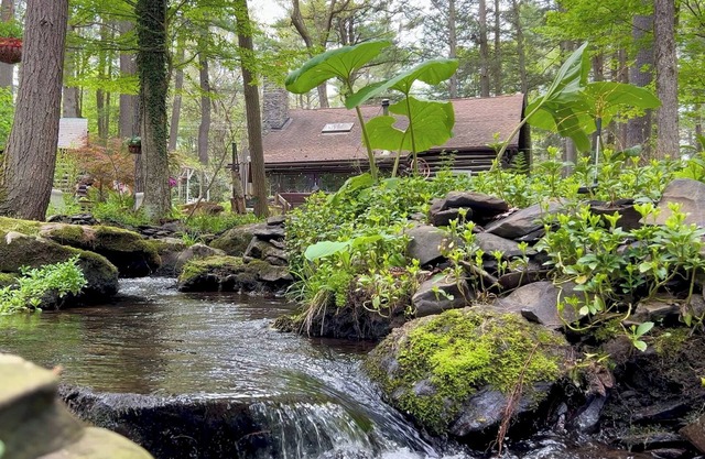 Rustic Rest Log Cabin, with hot tub and trout stream, near Poconos attractions.