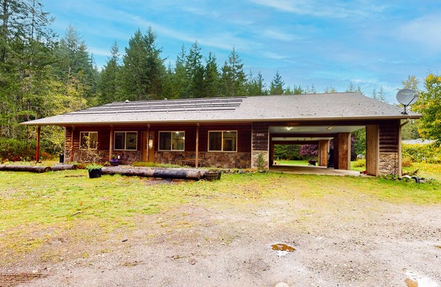 Scenic dog-friendly home with forest views, firepit, wood stove, & W/D