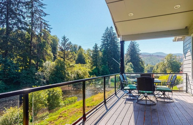 Scenic river-view retreat with patio, firepit, deck, grill, & game room