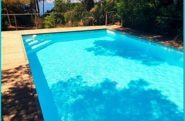 Seafront with direct beach access and private heated pool in a green setting