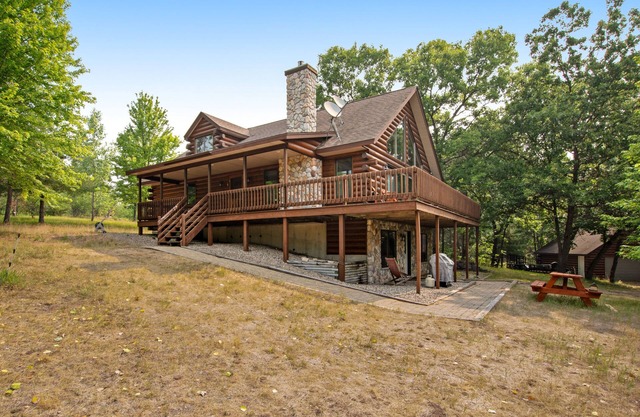 Secluded, dog-friendly home with tree-lined view, firepit, fireplace, & deck