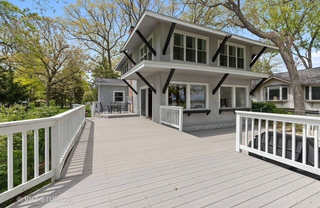 Serene lakefront house with expansive deck and pier