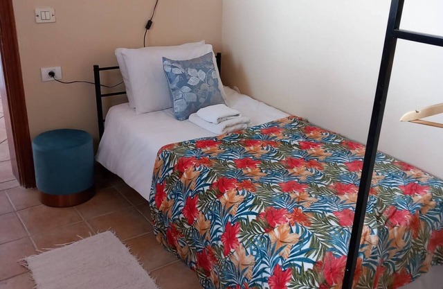 Single room with a single bed and en-suite bathroom. The window looks out onto the patio area