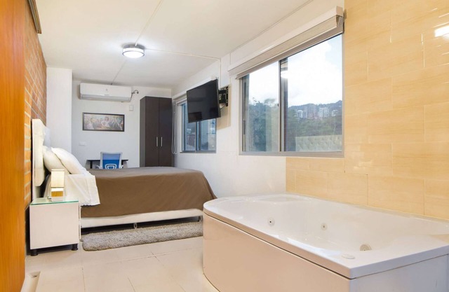 Studio AC, Hot Tub Two flat screens queen bed printer.