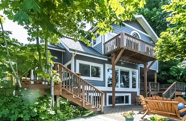 Stunning riverfront home w/ spacious deck, grill, two kitchens, & private dock