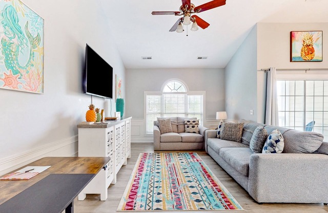 Sunny condo with pool access, coastal theme, balcony, W/D, and central AC