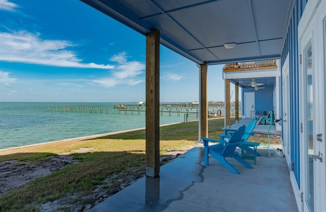 Sweeping views of Copano Bay from this newly constructed ground floor condo with a pool and a new fishing pier!
