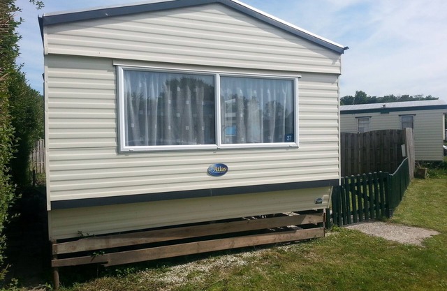 The caravan is surrounded by hedges. Children and dog friendly
