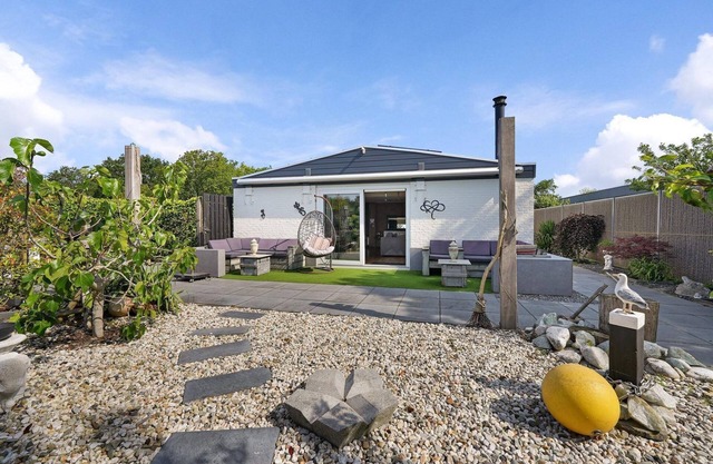 The charmingly furnished holiday home with luxurious amenities and a spacious private garden is located near the sea and dunes.