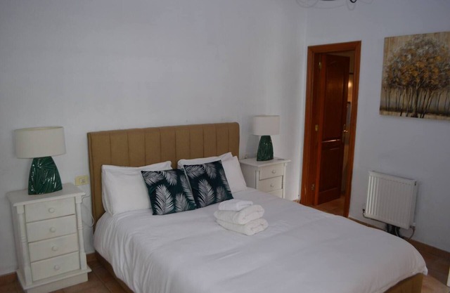 This is a double room with a double bed. It has an en-suite bathroom. The window in the room looks out into the hallway.