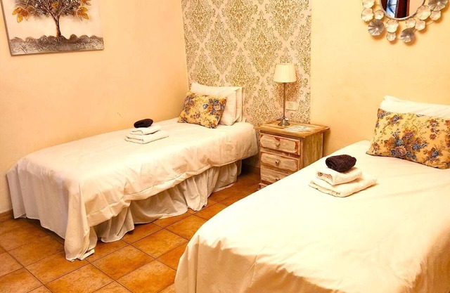 This room has two single beds with an en-suite bathroom. The room looks onto the road and has mountain views to the rear of the building.