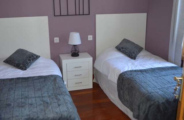 This twin room has two single beds with a private separate bathroom (bathroom across the hallway). The view is of the whole garden area and the sea can be seen on clear days.