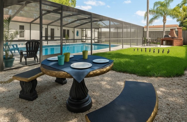 Tranquil Times | Serene 3BR Close to RJ Stadium | Screened Heated Pool | Patio Lounge area |Yard Che