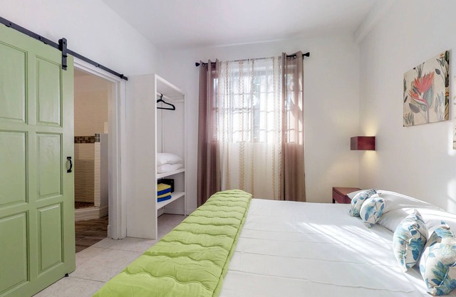 Two open, tropical studios w/WiFi, partial AC & great location near the beach
