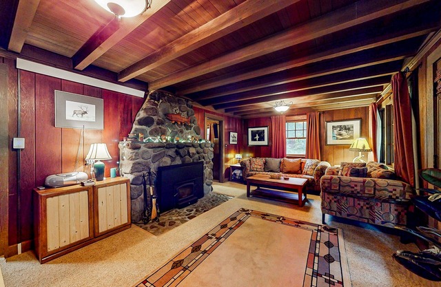 Unwind in nature's embrace at a 1925 cabin with hot tub & river views