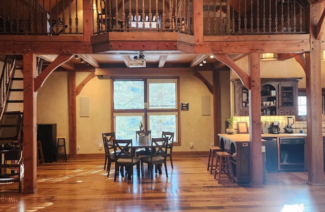 Vaulted beam ceilings, a huge rock fireplace, stream nearby, large campfire area